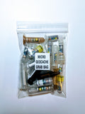 A clear plastic bag labeled 'MICRO GECACHE Grab bag containing various small containers for geocaching, with a blank Rite in the Rain®  log sheet included.